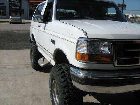 1993 Ford Bronco - This lifted 1993 Ford Bronco features large off-road tires and a chrome bumper.