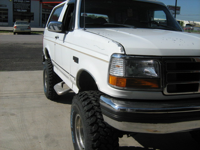 White 1993 Ford Bronco with lifted suspension and large tires