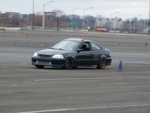 2001 Mercury Grand Marquis - A dark green coupe with racing numbers is seen on a track, likely participating in an event.