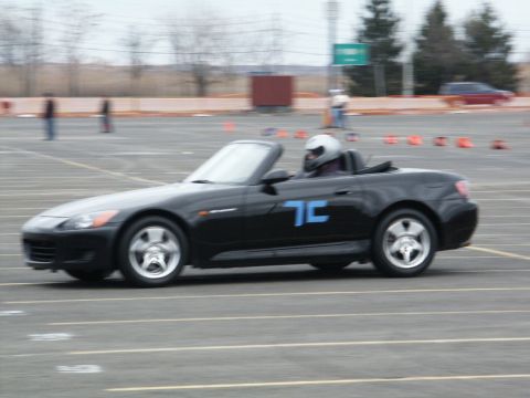 2001 Mercury Grand Marquis - A black convertible is driven on a track with orange cones marking the course.