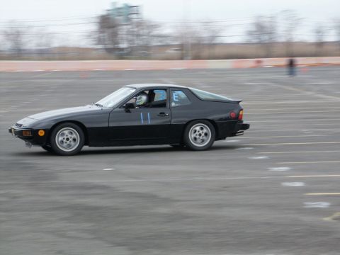 2001 Mercury Grand Marquis - A black coupe with racing numbers is seen on a track during a timed event.