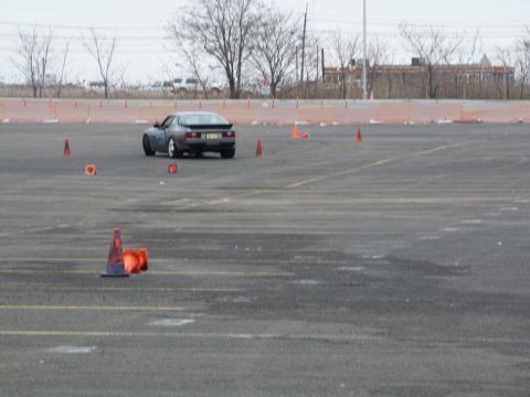 2001 Mercury Grand Marquis - A Porsche 944 navigates a course marked by traffic cones on an asphalt lot.