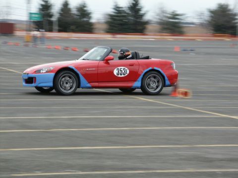 2001 Mercury Grand Marquis - Red convertible sports car with blue accents and racing number 353 on a track.