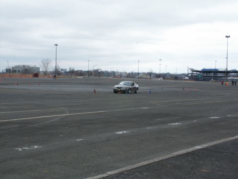 2001 Mercury Grand Marquis - A Ford Mustang navigates a course marked by cones on a cloudy day.