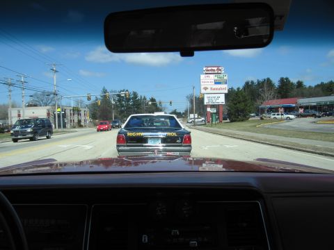 1991 Ford Crown Victoria - Following a 1991 Ford Crown Victoria marked 'Highway Patrol' on a sunny day.