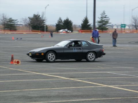2001 Mercury Grand Marquis - A black Porsche 944 coupe navigates a course marked by orange cones on a cloudy day.