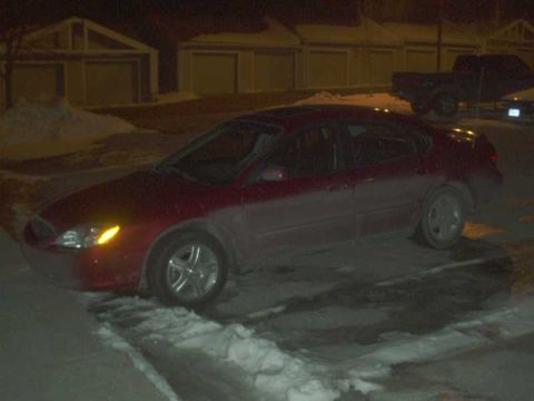 2000 Ford Taurus - a side view at night. notice all the buildup after 2 days in the winter.