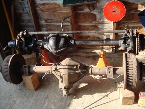 1978 Chevrolet C/K Pickup - Two truck axles, one with disc brakes and the other with drum brakes, are shown supported by jack stands.