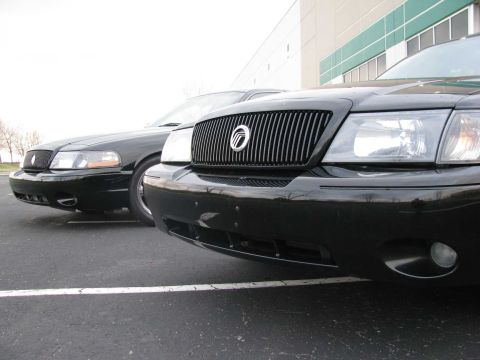 2003 Mercury Marauder - Two black 2003 Mercury Marauders are parked in a lot, showing their distinctive grilles and headlights.