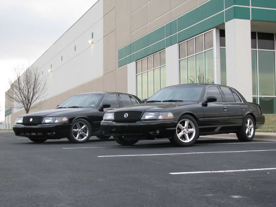 Two black 2003 Mercury Marauders parked in a lot