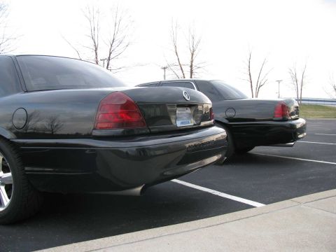2003 Mercury Marauder - Two black 2003 Mercury Marauders are parked in a lot, showing their rear ends.