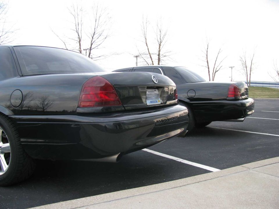 Two black 2003 Mercury Marauders parked side-by-side in a parking lot