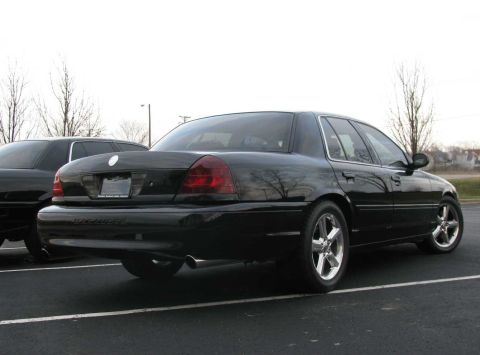 2003 Mercury Marauder - A black 2003 Mercury Marauder is parked next to another car, showing its rear profile and side profile.