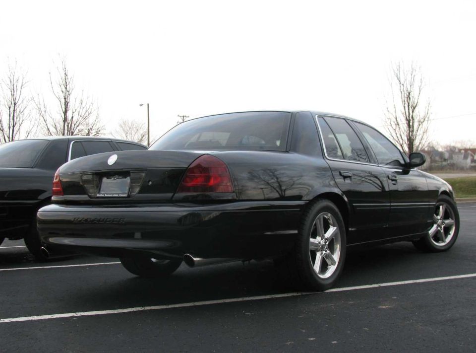 Black 2003 Mercury Marauder sedan parked, rear 3/4 view, chrome wheels, tinted taillights