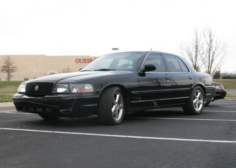 2003 Mercury Marauder - A black 2003 Mercury Marauder is parked in a lot with a Guess store in the background.