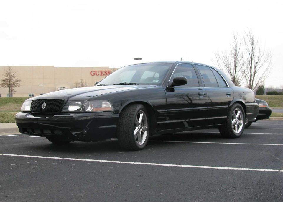 Black 2003 Mercury Marauder parked in a lot, another car behind it