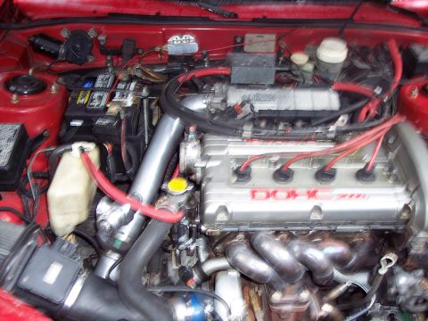 1992 Mitsubishi Eclipse - Close-up of an engine bay, a DOHC 2000 badge and turbocharger plumbing.