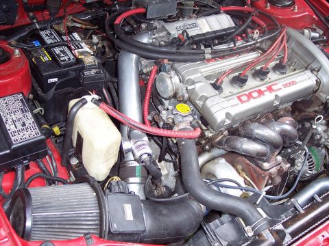 1992 Mitsubishi Eclipse - Close-up of a car's engine bay, a DOHC 2000 engine with various components visible.