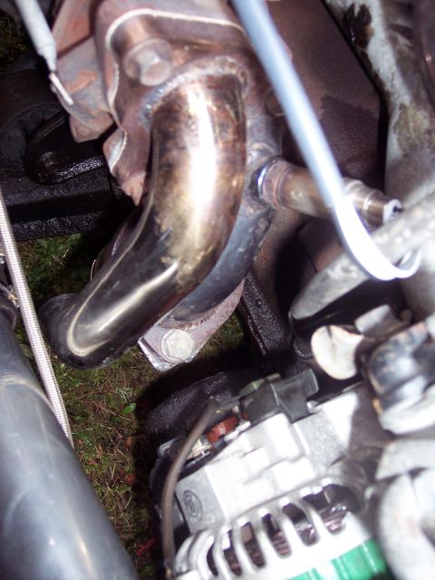 1992 Mitsubishi Eclipse - Close-up view of engine components including the exhaust manifold and alternator.