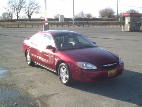 2000 Ford Taurus - This 2000 Ford Taurus is shown in a three-quarter front view, a red exterior and a yellow license plate.