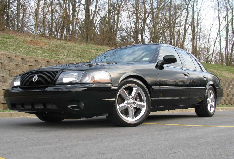 Black Mercury Marauder sedan, low front three-quarter view on polished five-spoke wheels