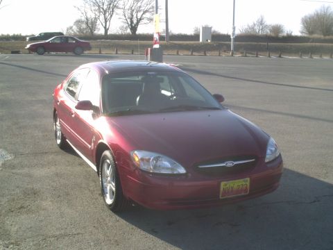 2000 Ford Taurus - Front 3/4 view of a red 2000 Ford Taurus parked in a lot.