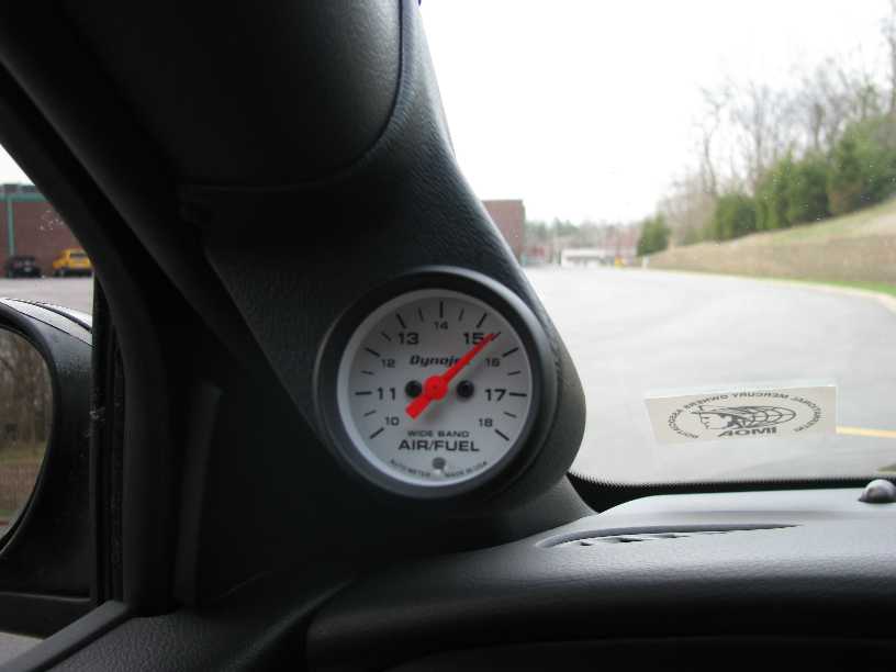 Interior shot of a car's air-fuel ratio gauge mounted on the A-pillar