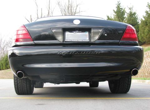 2003 Mercury Marauder - Rear view of a black 2003 Mercury Marauder sedan with dual exhaust pipes and the model name visible on the trunk lid.