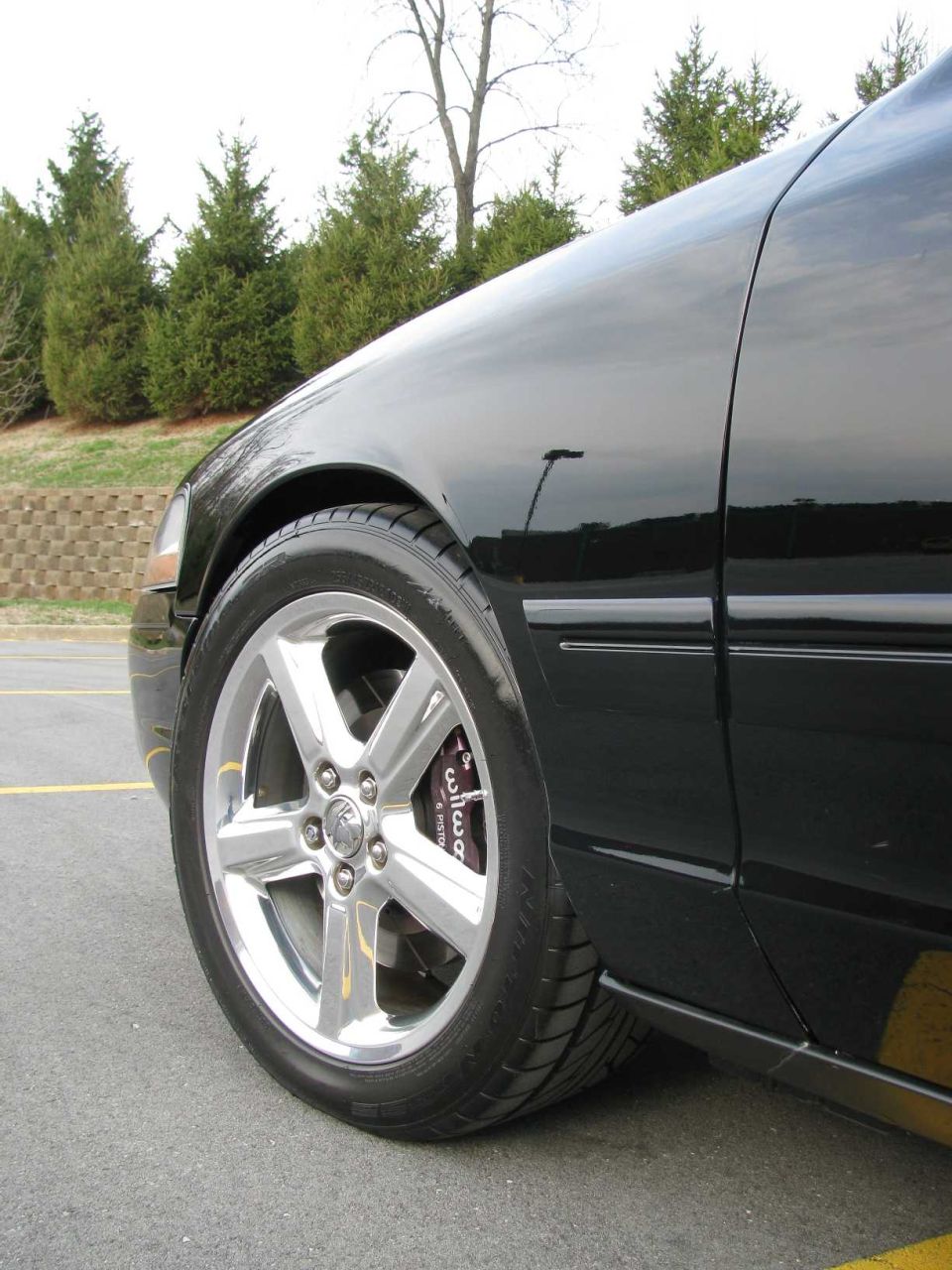 Black 2003 Mercury Marauder front wheel with chrome rims and performance brakes
