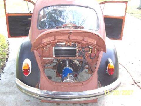 1991 Ford Bronco - The rear engine compartment of a classic Volkswagen Beetle is open, revealing its mechanical components.