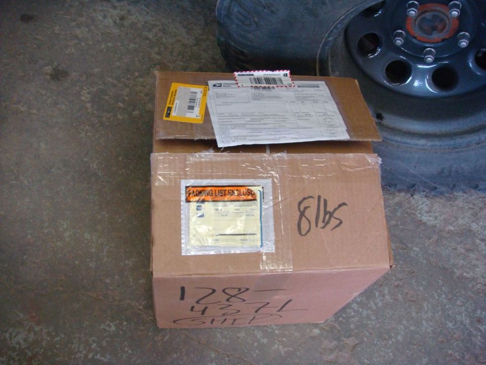 Cardboard boxes with shipping labels and handwritten weight
