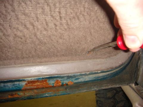 1996 Ford Bronco - Rust is visible on the lower edge of the interior door panel of a 1996 Ford Bronco.