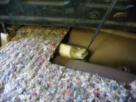 1996 Ford Bronco - Close-up view of the interior door panel mechanism and insulation.