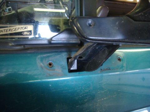 1996 Ford Bronco - Close-up of the door handle and mirror mounting area on a 1996 Ford Bronco, showing the 'INTERCEPTOR' badge.
