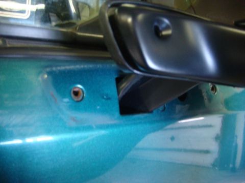 1996 Ford Bronco - Door panel and side mirror mounting area on a teal vehicle.