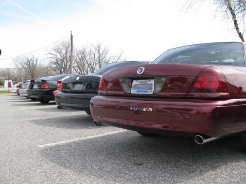 2003 Mercury Marauder - Several sedans are parked in a lot, with the rear of a maroon Mercury Marauder in the foreground.