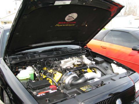 2003 Mercury Marauder - The hood liner of a 2003 Mercury Marauder displays "Marauder Supercharged" text, highlighting the vehicle's performance modification.