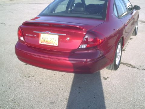 2000 Ford Taurus - Rear view of a red 2000 Ford Taurus sedan with license plate NVX 273.