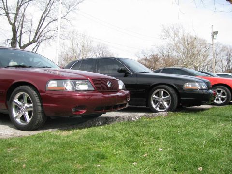 2003 Mercury Marauder - Three sedans are parked in a row on a grassy area.