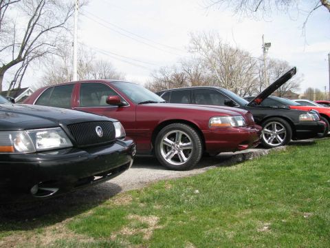 2003 Mercury Marauder - Several Mercury Grand Marquis sedans are parked in a row on a sunny day.