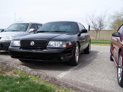 2003 Mercury Marauder - A black 2003 Mercury Marauder is parked next to another vehicle.