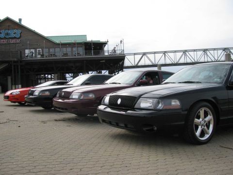 2003 Mercury Marauder - Several sedans, including a black 2003 Mercury Marauder, are parked outside Joe's Crab Shack.