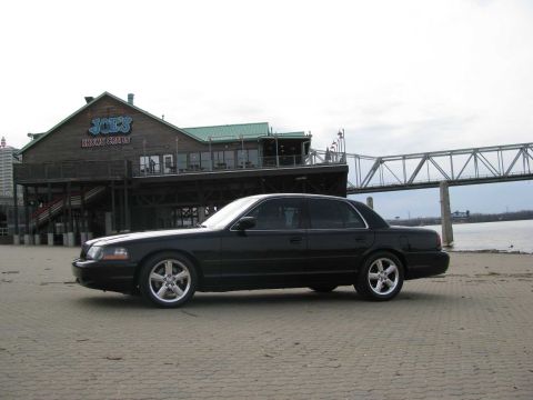 2003 Mercury Marauder - Black 2003 Mercury Marauder parked on pavement with a building and bridge in the background.