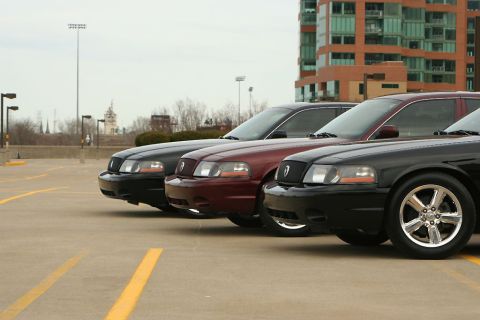 2003 Mercury Marauder - Three 2003 Mercury Marauders are lined up in a parking lot, showing their front 3/4 profile.