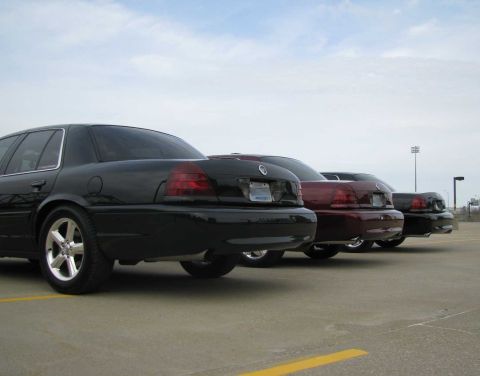 2003 Mercury Marauder - Three 2003 Mercury Marauders are parked in a line on a paved surface under a cloudy sky.