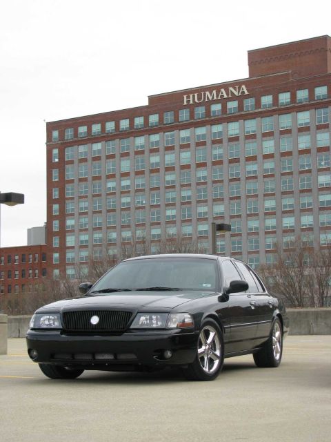 2003 Mercury Marauder - A black 2003 Mercury Marauder is seen from the front-three-quarter view, parked in front of a large brick building.