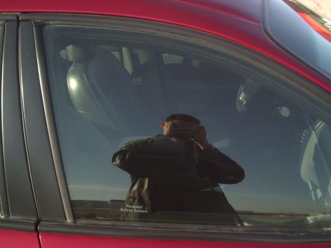 2000 Ford Taurus - Reflection of photographer in car window, interior visible, with 'Personal Safety System' text on door.