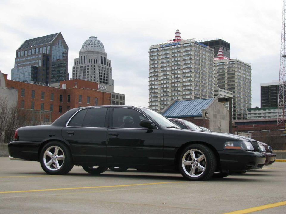 Black 2003 Mercury Marauder parked in front of city buildings