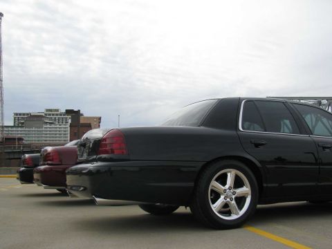 2003 Mercury Marauder - Three sedans are parked in a lot, with the rear of a black 2003 Mercury Marauder in the foreground.