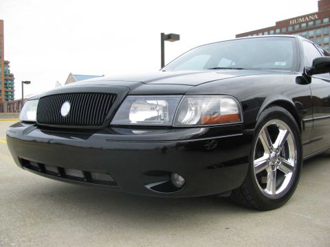 2003 Mercury Marauder - A black 2003 Mercury Marauder is shown from the front quarter angle, its distinctive grille and chrome wheels.
